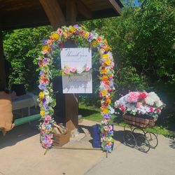 Flower arch and vintage stroller with flowers