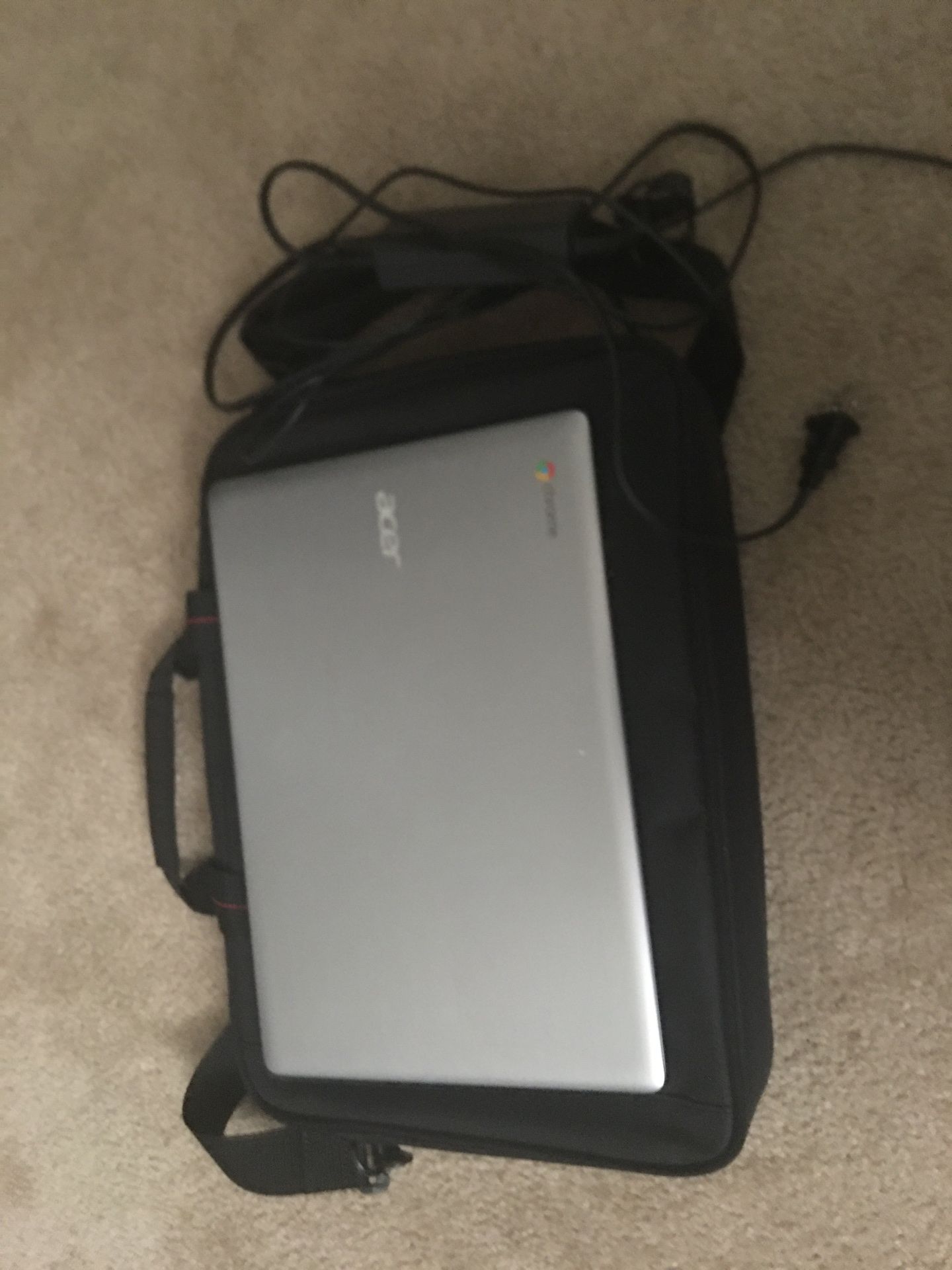 ACER Chromebook with a charger and computer bag