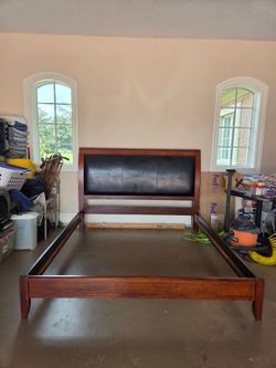 King size bed frame. Wood and leather headboard.