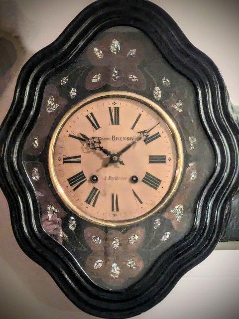 Rare beautiful antique French wall clock from 1800s with glass face and ebonized mother of pearl design. Have seen these selling for $300 - $1,500.