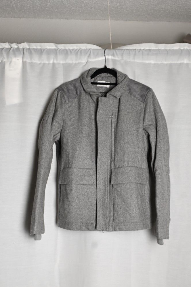 Men's wool jacket with a zip front and large front pockets.