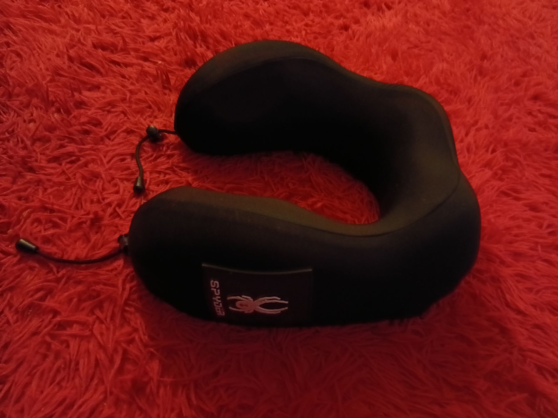 Spyder branded black travel neck pillow