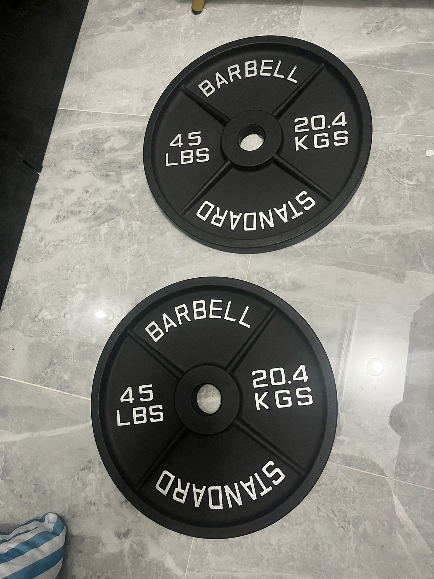 New in box never used pair of 45lb Olympic weight plates total 90lb have ez curl bar new in bag for sale too for additional price the third picture is