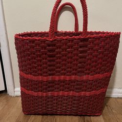 Red hand woven plastic tote