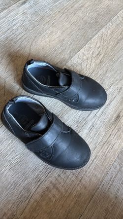 Boy toddler dressing shoes