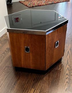 Mid Century Hexagonal Chrome Accent Side Table/ Cabinet. It consist of smoked glass top with chrome trim and hinged door, it rests on a plinth base. I