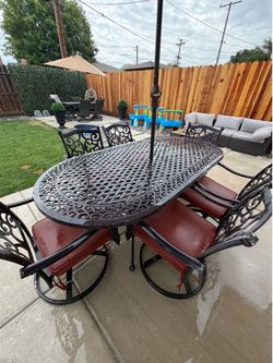(FREE DELIVERY. )1,000 $$ Beautiful all metal patio set with six swivel rocking chair, chairs with cushions an umbrella with umbrella stand