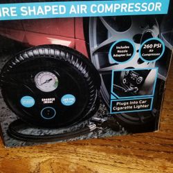 NEW IN BOX SHARPER IMAGE TIRE SHAPED AIR COMPRESSOR.  PICK UP MIDDLEBORO ONLY FINAL SALE 