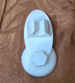 Handy white shower head holder. Has a strong suction cup for easy installation on smooth surfaces. Great for holding your handheld shower head where y