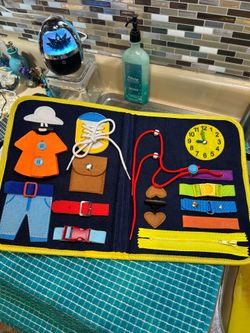 Felt Montessori Busy Board designed to help toddlers develop fine motor skills