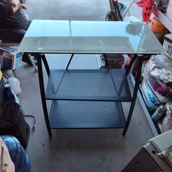 The Top Side Is Glass And The Bottom Is Metal Desk