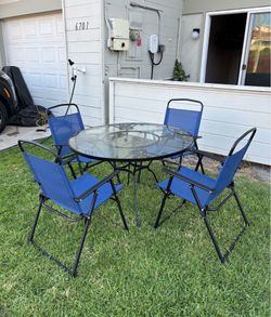 Beautiful Outdoor Glass And Wrought Iron Patio Table With 4 Folding Chairs
