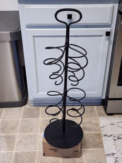 Wrought iron bottle holder spiral metal decor

Pre-owned and in excellent condition!

About 31" tall and 10" wide base