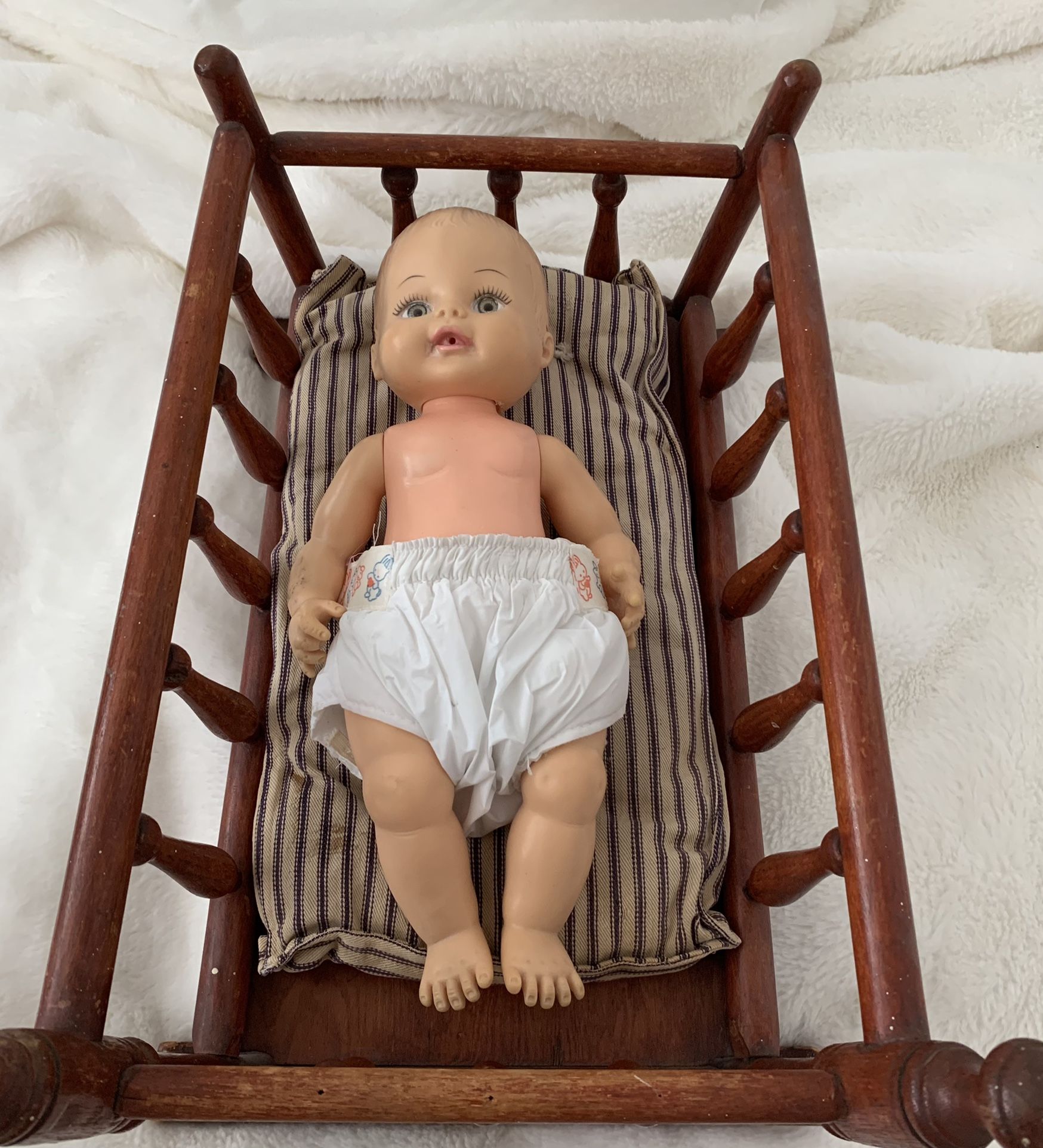 Vintage rocking baby crib, handmade in Connecticut. Made in the 1960s. Vintage baby doll, 1972. Original mattress that came with rocking crib.