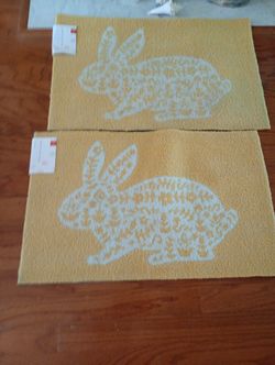 2 matching rabbit rugs