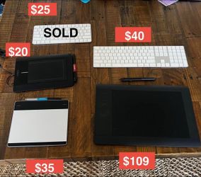 Wacom professional digital tablets with pen and Apple wireless keyboards