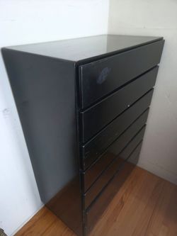 Black wood dresser with seven drawers.