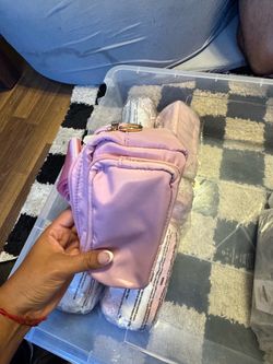 6 Pink Mini Crossbody Bag. 2 smaller black cross body. 7 Black bags. 2 light brown back packs and 2 pink bigger cross body bags