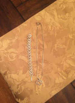 Necklace and bracelet. “GOD” spelled out in two tone.