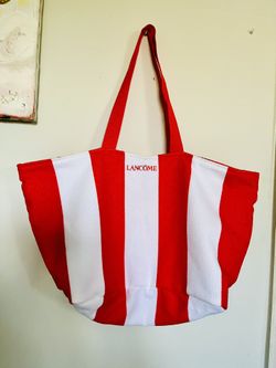 Large beach tote bag polyester towel look material. Dark orange and white strips. 23” wide on the top, 16” inches wide at the bottom, 12” tall and 7.5