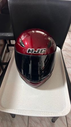 Small red burgundy motorcycle helmet HJC with smoke visor screen