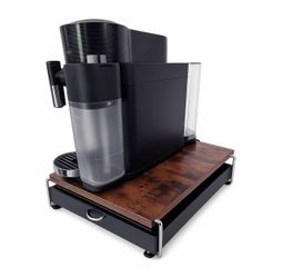 De'Longhi Nespresso Vertuo Coffee and Espresso Machine with stand and pods.