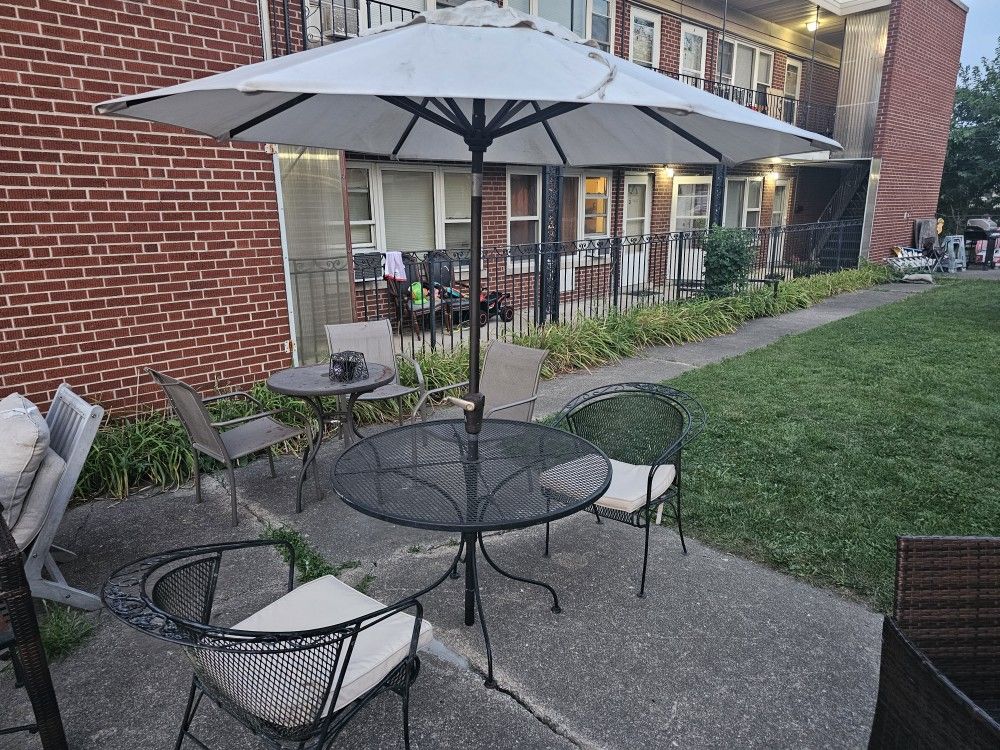 metal table and 2 chairs and umbrella