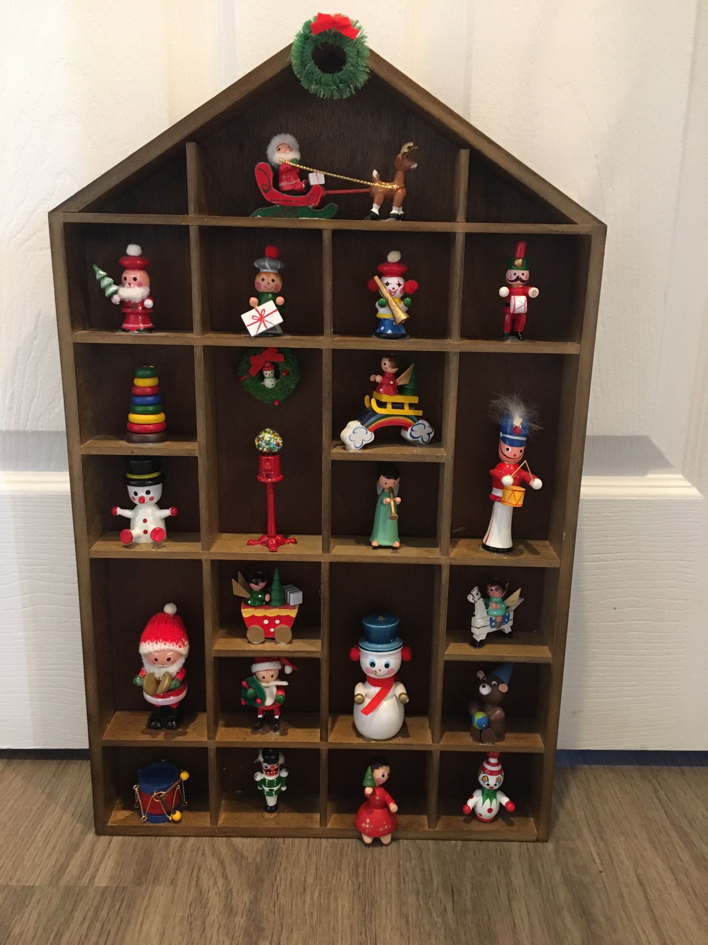 Wooden Christmas House With Whimsical Items In Each Box