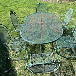 Seven piece vintage patio furniture with big table and six spring rocker chairs wrought iron