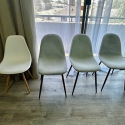 Four Comfortable Dining Chairs Light Blue Fabric And One Is White Plastic