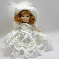 Porcelain doll in a white dress for a wedding