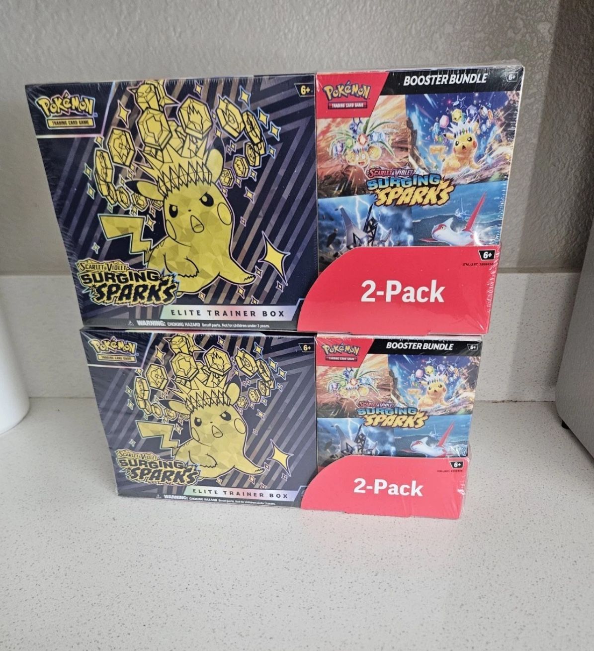 Pokémon TCG Scarlet & Violet Surging Sparks Lot – 2 ETBs + 2 Booster Bundle...