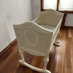 Wicker embossed wood rocking cradle in a Victorian style antique white finish, Includes mattress 