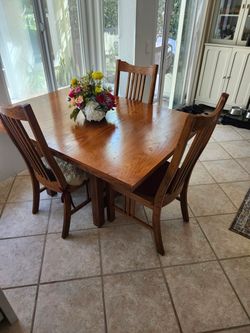 Solid wood dining room table with 3 chairs
