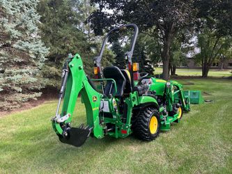 John Deere 1025R compact diesel 4x4 with backhoe, loader bucket and 60 in drive over deck