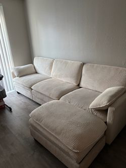 Beige cream white colored couch
