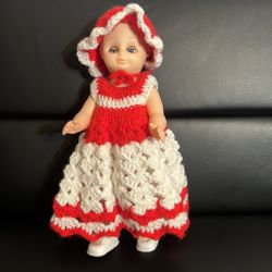 Vintage doll with crocheted, red and white dress