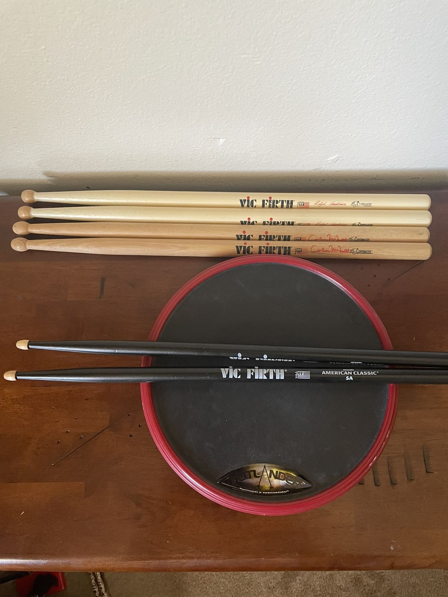 Outlander offworld percussion practice pad with three vic firth drumsticks