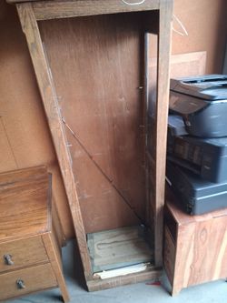 Wooden curio cabinet with glass shelves