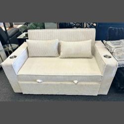 Beige convertible sofa with sleeper bed with cup holders 