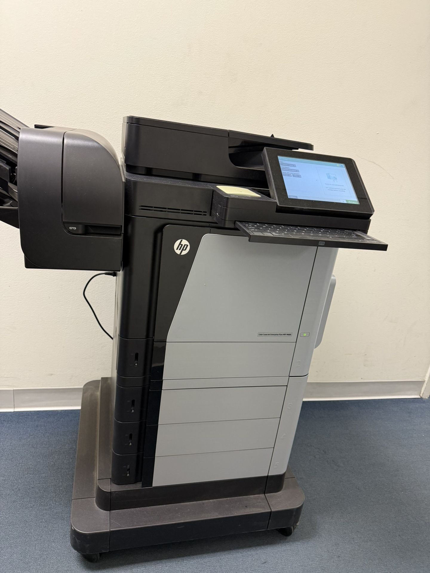 HP Color LaserJet Enterprise MFP M680 multifunction printer designed for high-volume printing in a business or office setting. It is capable