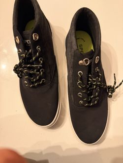Sperry Authentic Original Lug Chukka boots in a dark gray color with yellow and black laces. 