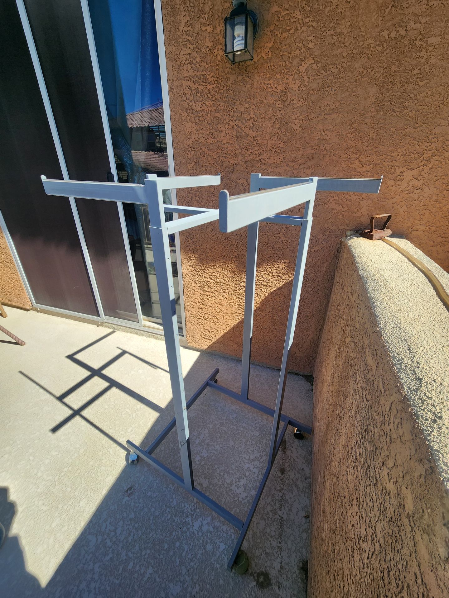 Steel Cloths rack on castor locking wheels. Store style. 4 arms different directions with adjustable heights. Can be same or ea arm different heights.