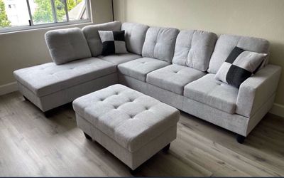 Gray linen sectional couch and ottoman