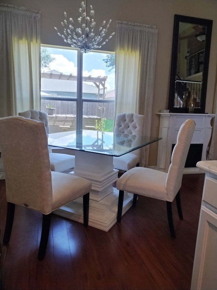 Custom made pedestal, glass top table, and light cream upholstered chairs