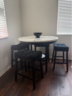 Marble table with black stools