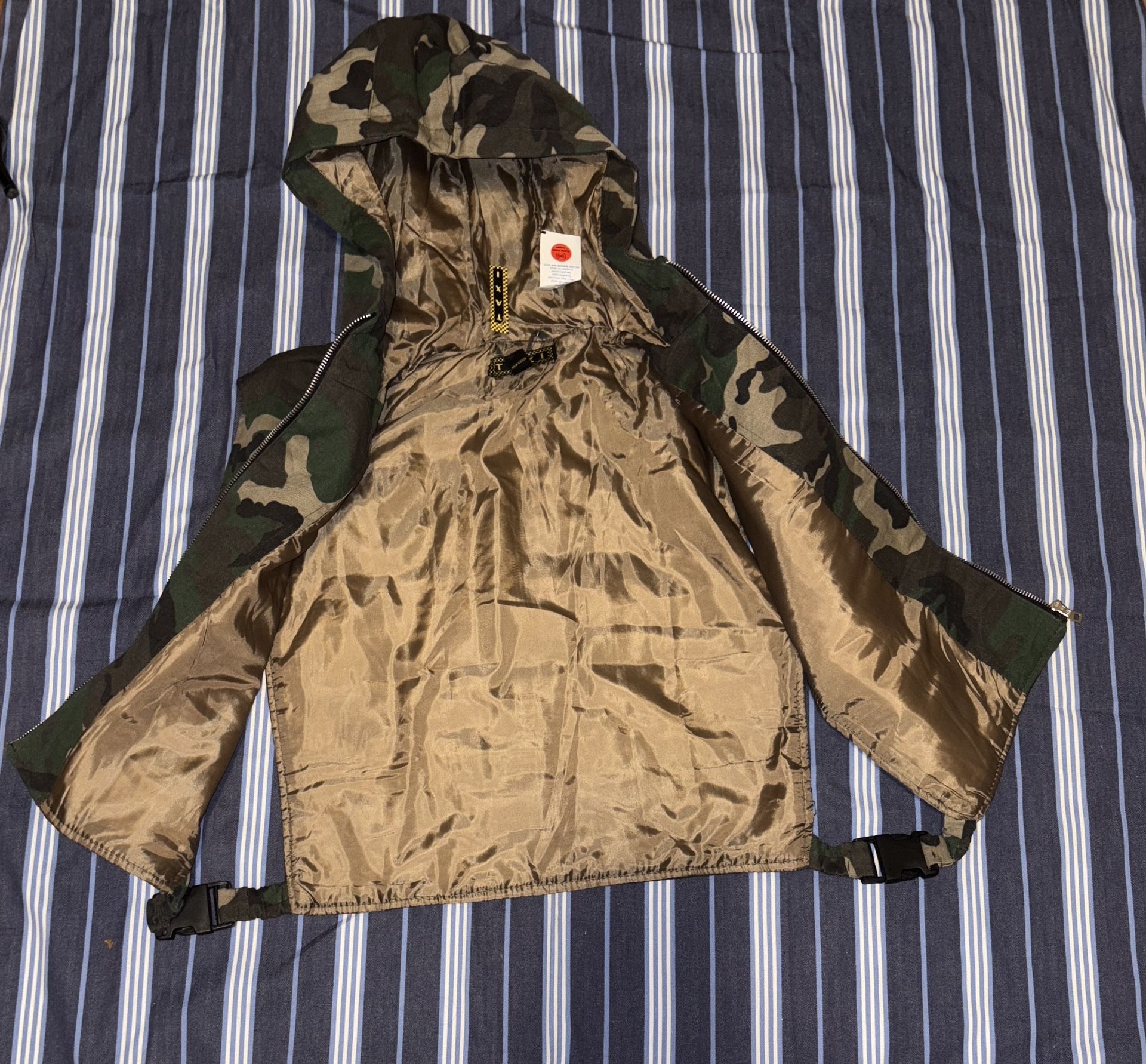 Stylish sleeveless camouflage hooded vest with a zip front. Perfect for layering.