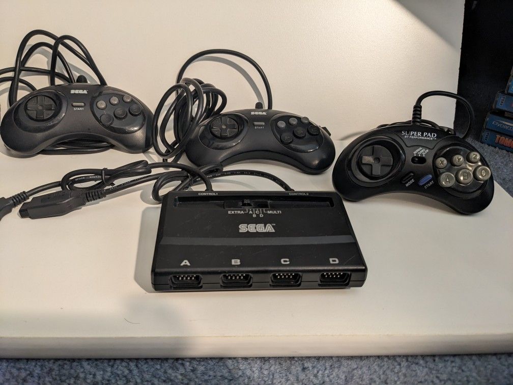 Sega Genesis Controllers And Multitap. 