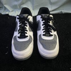 Nike Air Force 1 sneakers in a white, gray, and black colorway