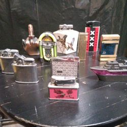 A Collection Of Various Vintage Or Novelty Cigarette Lighters.